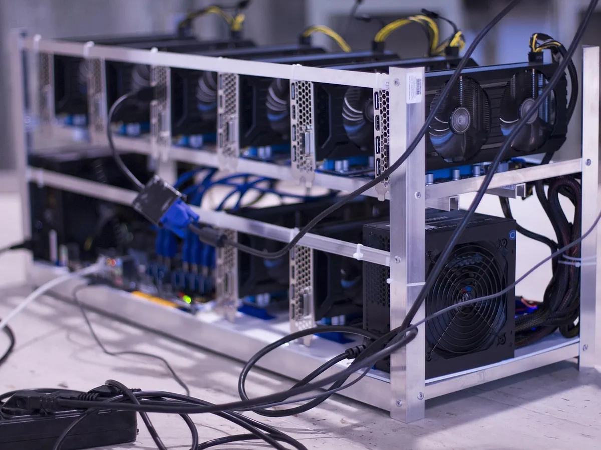 Row of ASIC mining machines running in a dim data facility