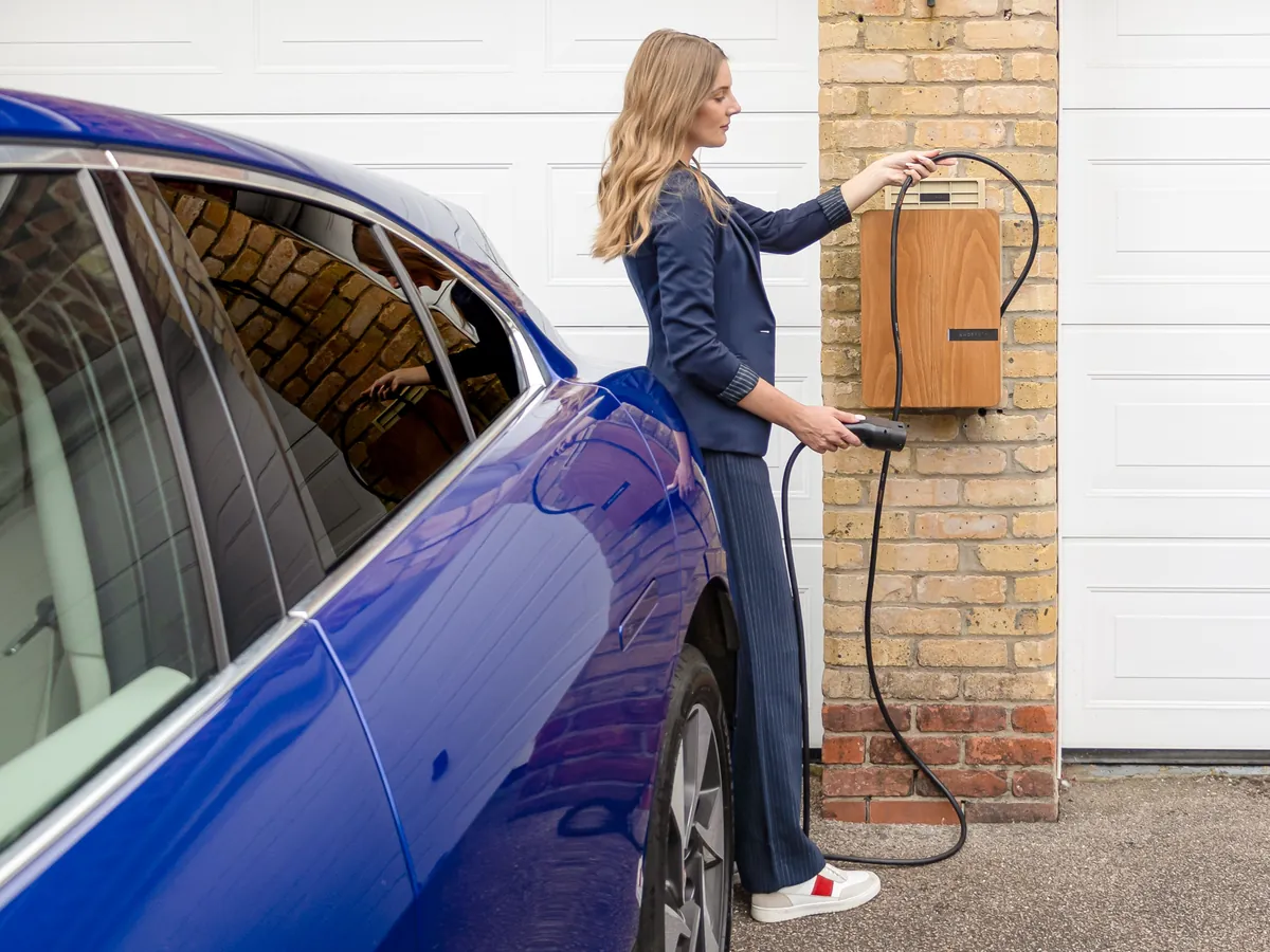 Electric car plugged in overnight in a residential driveway