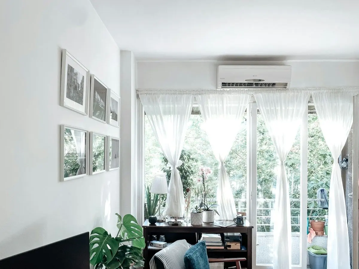 Ductless mini-split indoor unit mounted high on a living room wall