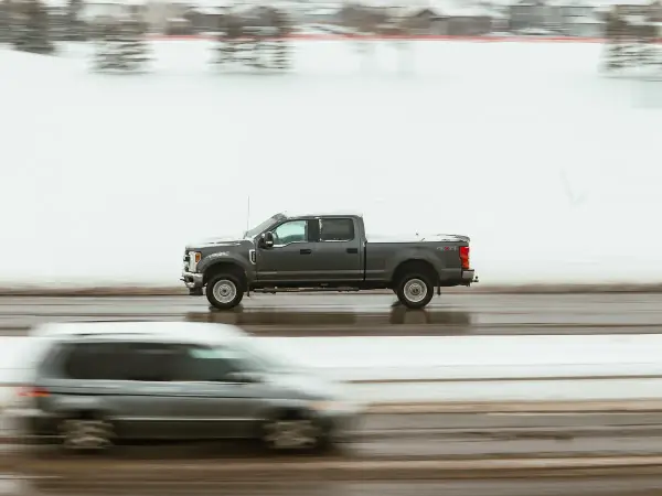 Pickup truck in motion on a highway at dusk