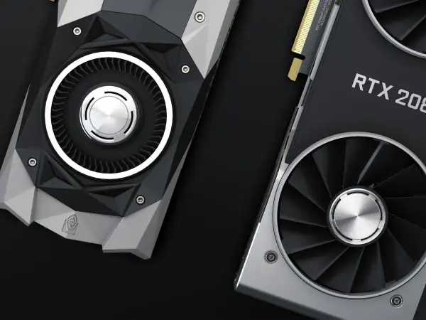 Graphics card connected to an open PC power supply on a workbench