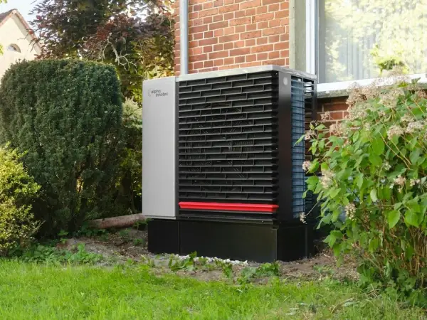 Modern heat pump outdoor unit in a residential garden