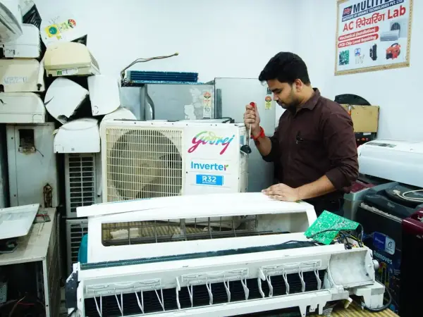 Technician servicing a ductless mini-split air conditioner