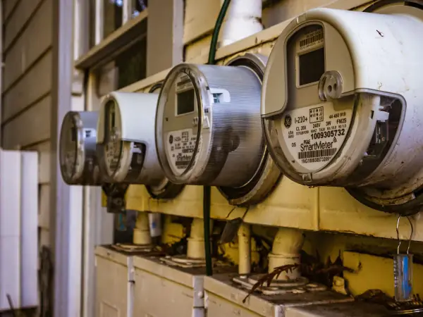 Residential electric meter mounted on a house exterior wall
