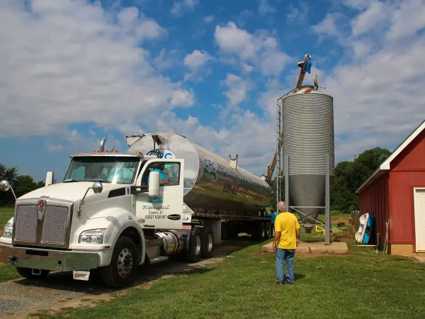 Home heating oil delivery truck parked beside a house